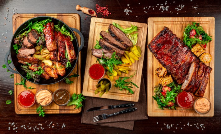 Plates of meat sitting on the counter