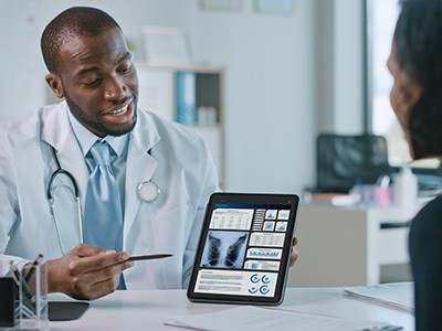 Physician talking with a patient about their lung screening