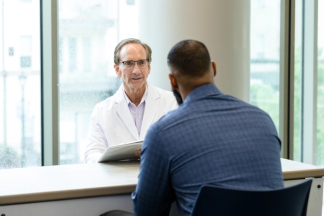 Male doctor speaking with patient about prostate