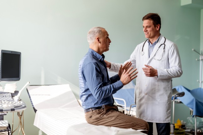 Man talking to urologist in doctor's office