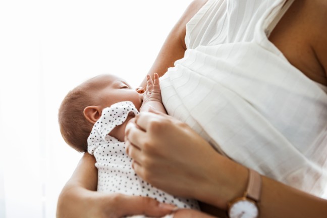 Mom breastfeeding to newborn baby