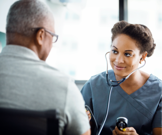 A cardiologist holds a stethoscope to check her patient's heart rate and rhythm. 