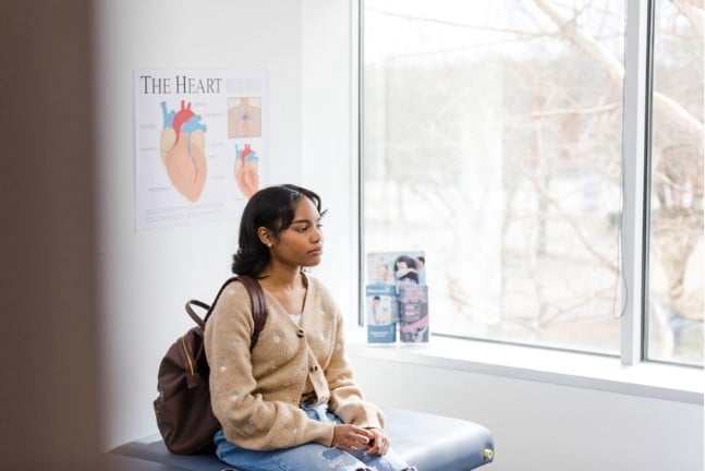 Young woman sitting in doctor's office