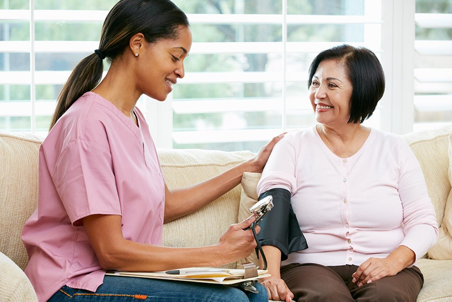 Woman getting blood pressure read at home